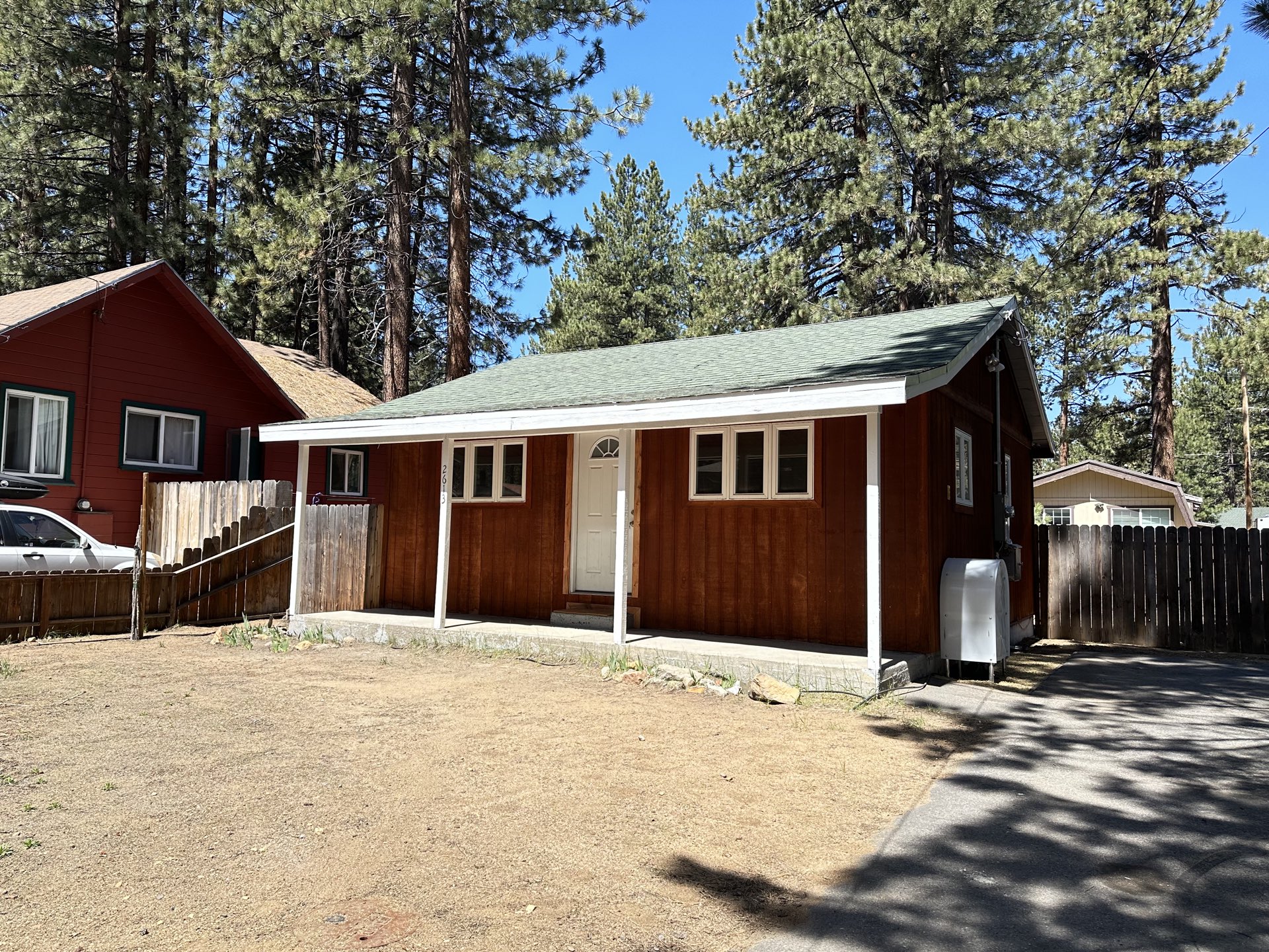 The Fountain Ave Cabin seen from the street, under the pines